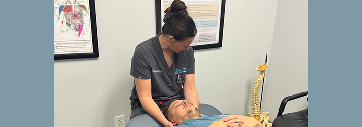 Shelby Tate adjusting a patient's neck.