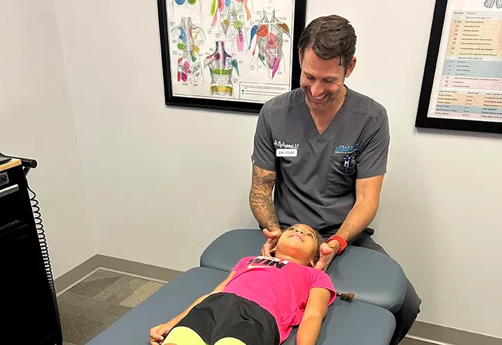 Chiropractor Rock Hill SC Dr. Clay Gasparovich Adjusting a Patient.